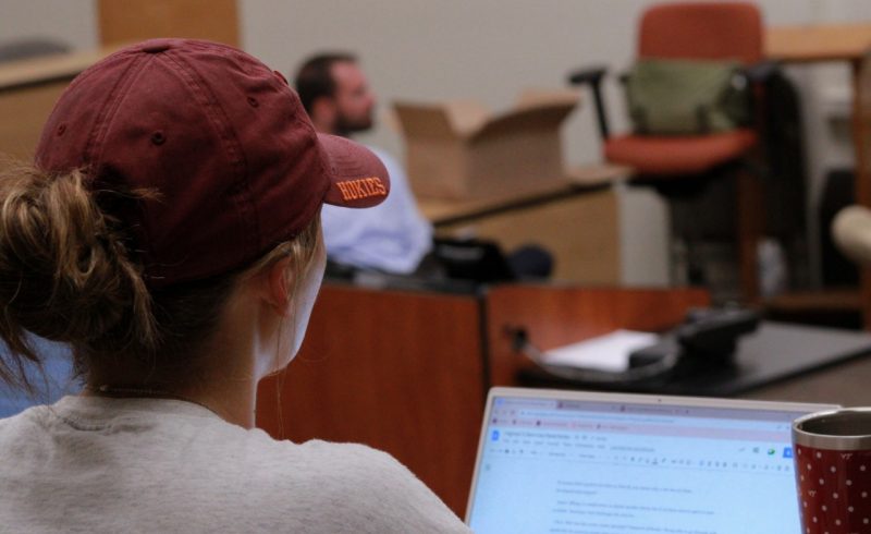 Woman wearing a Virginia Tech hat in class