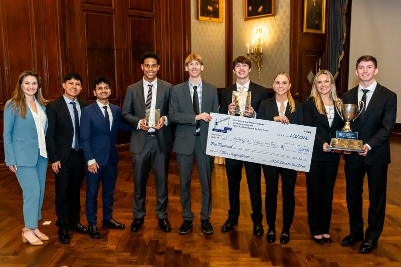 Winning student teams pose with top prize check and trophies.